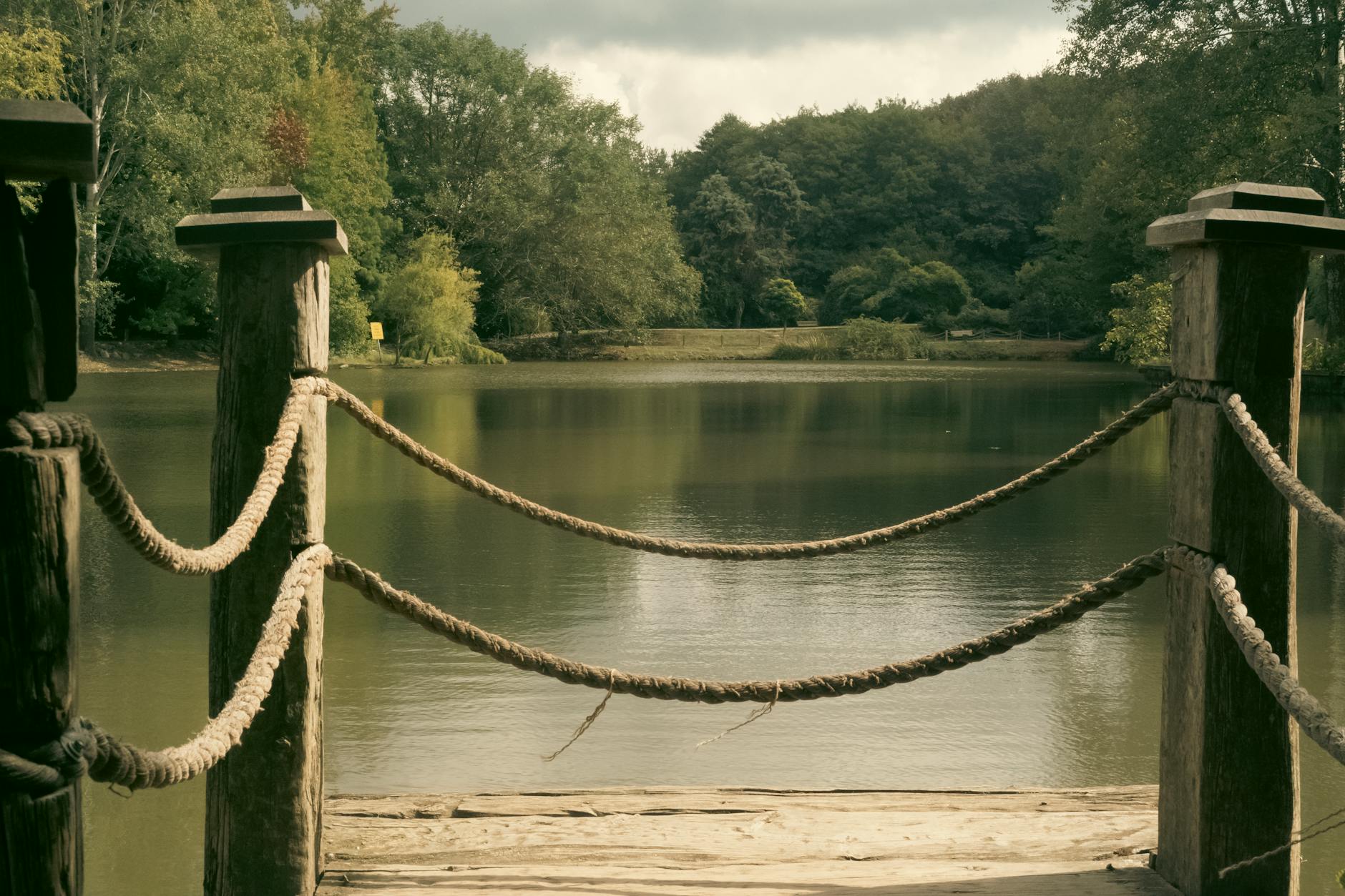 Muelle de madera con cuerdas frente a un tranquilo lago en el Arboretum de Atatürk.